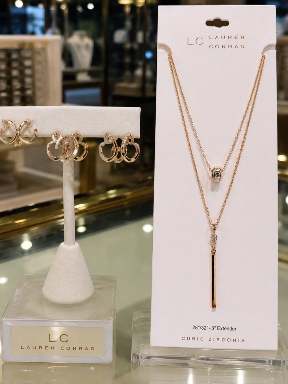 Gold-tone layered necklace with CZ bar pendant and three pairs of pavé CZ hoops